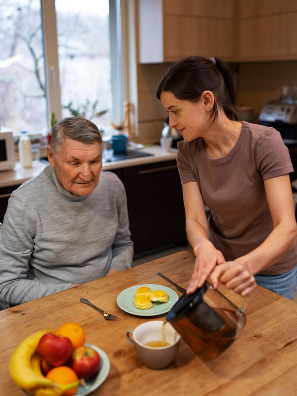 Caregiver assisting senior with tablet